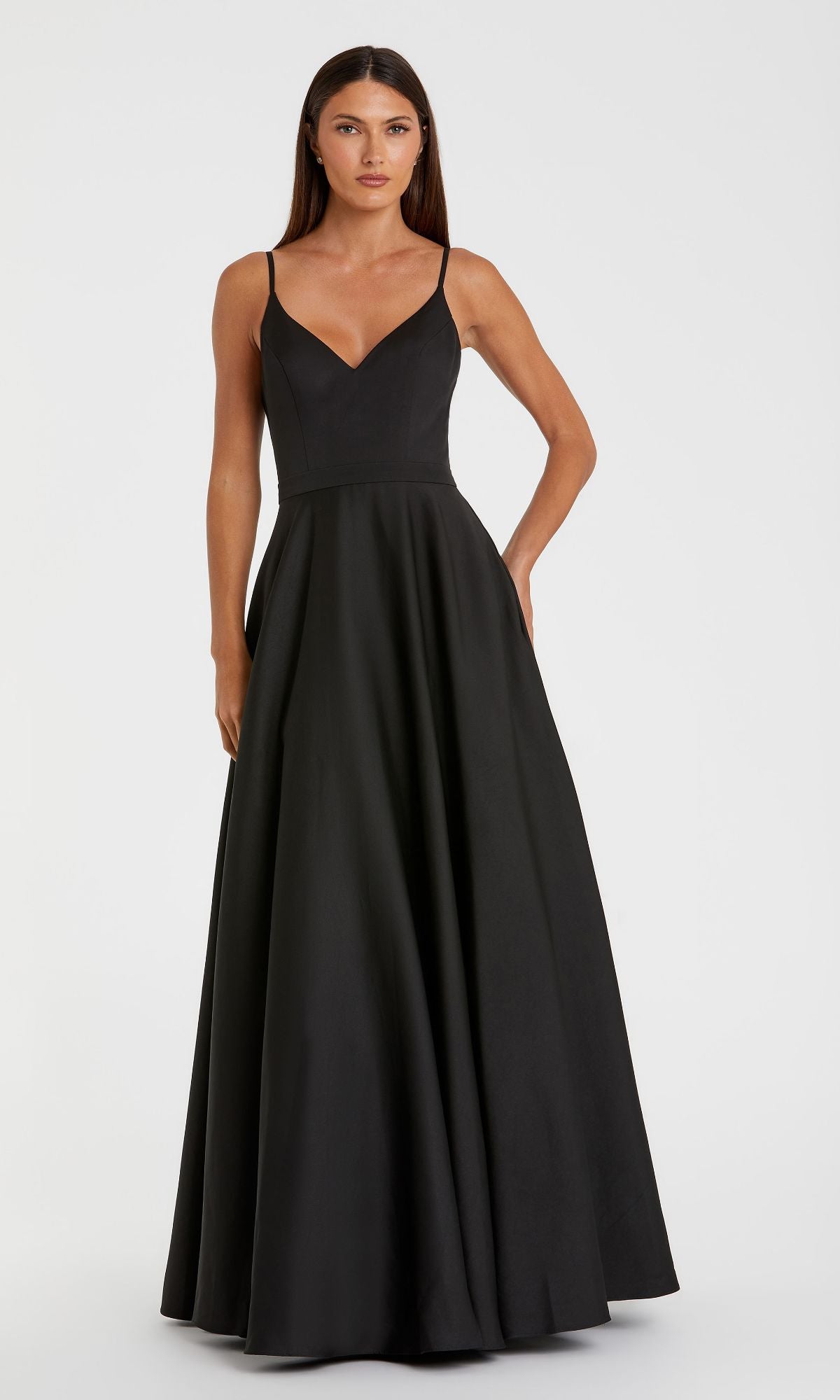 A woman models the Mac Duggal 48855 Classic Long A-Line Formal Dress with thin straps and a fitted bodice, standing against a plain white background.